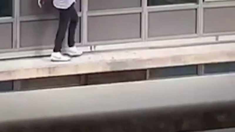 One misstep, and he could plunge 80 feet to his death