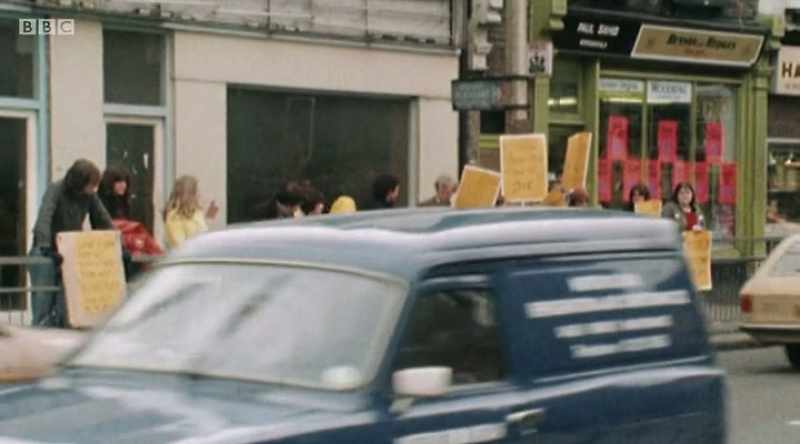 Opposite the police station, a small group gathered to protest