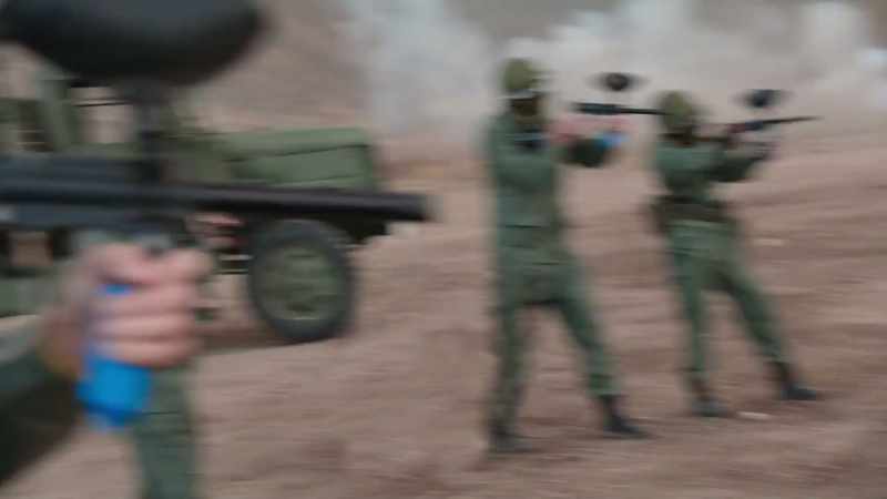 [paintball guns firing] - [