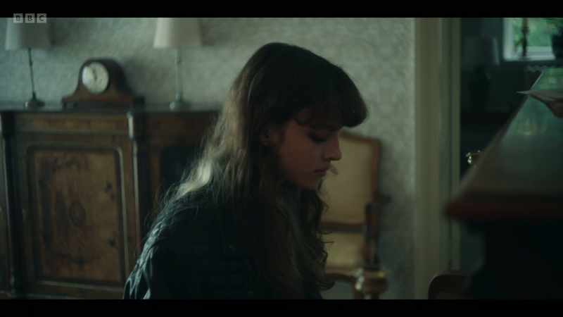 (piano playing) -(sombre music playing)