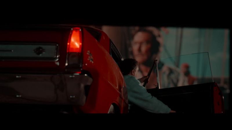 Pigtails twirling in front of a silver screen