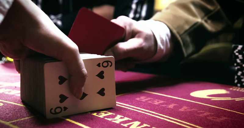 Player one makes his cut. Baccarat tradition