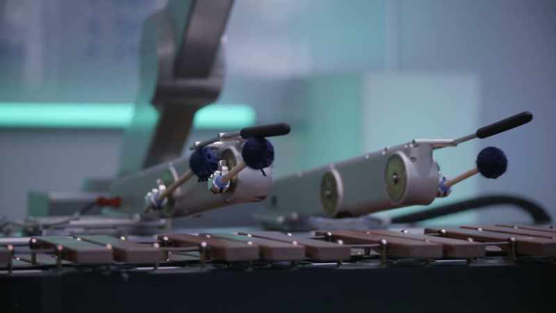 [playing marimba]