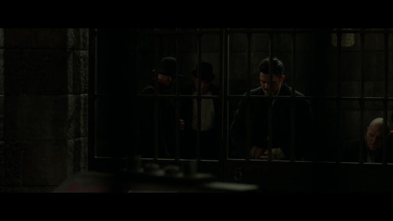 (prisoners speaking quietly)