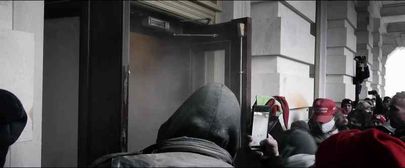 (protestors shouting) (door bashing)