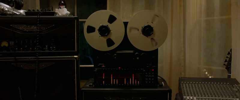 (Rock music playing over tape)