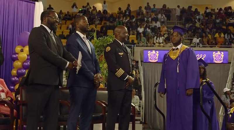 SCHOOL OFFICIAL [over microphone]: Tygee Newman Hill
