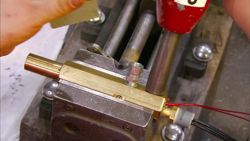 SHE CHECKS THESE FITTINGS WITH A LEVELING TOOL