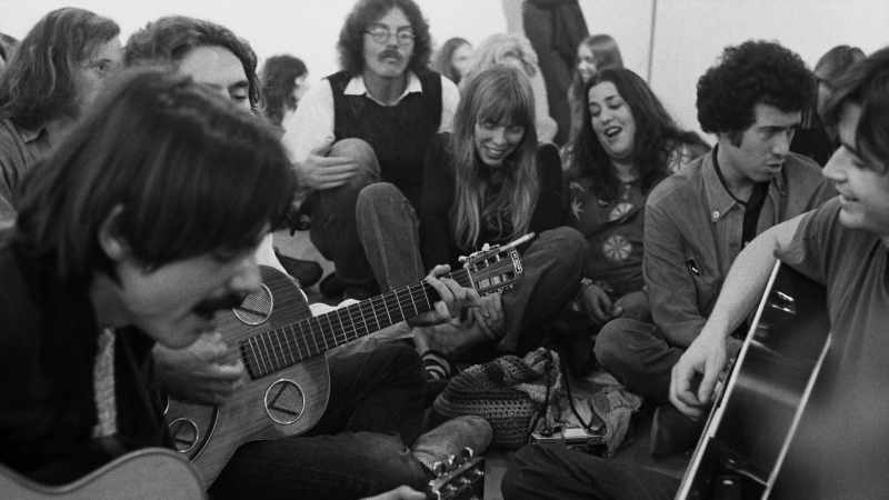 She comes stomping in with her guitar