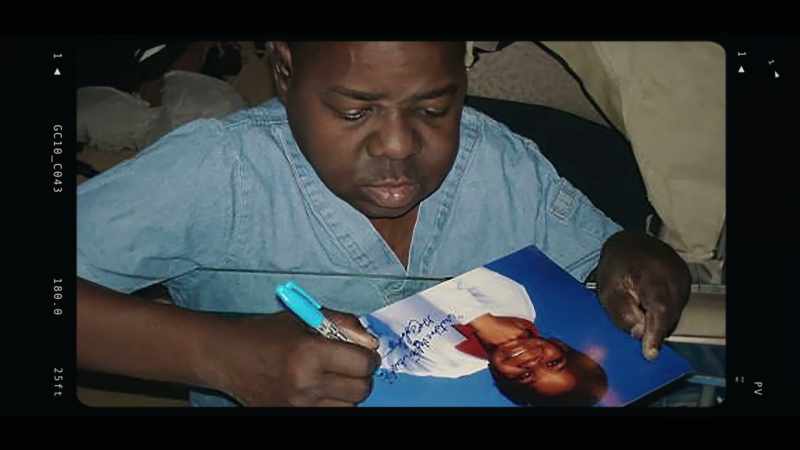 She was grabbing them, so that he could autograph and sell them