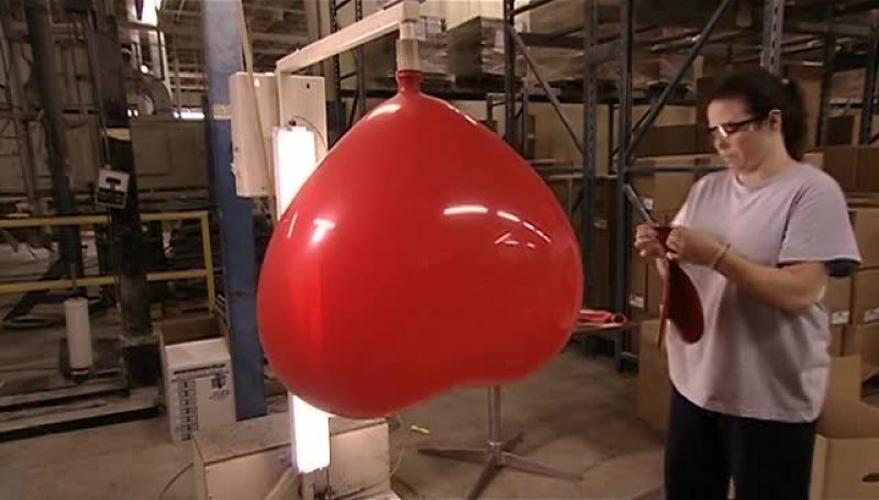 SHE HOLDS IT AGAINST A LIGHT