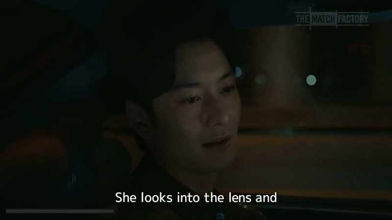 She looks into the lens and