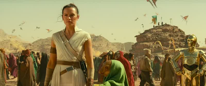 She is saying WelcomeHer name is Nambi GhimaThat's an excellent name I'm ReyShe would be honored to know your family name tooI don't have oneI'm just Rey