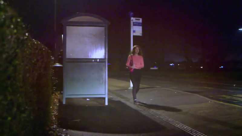 She's walking along the road. She's aware