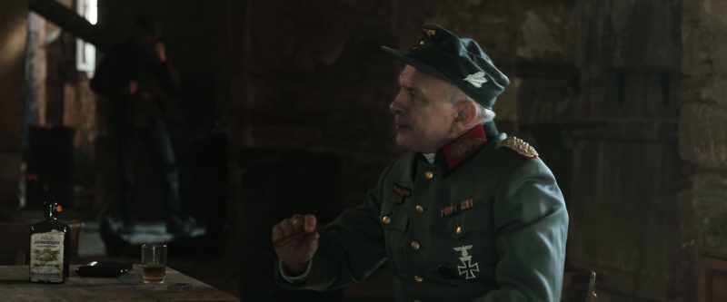 [soldier speaking in the background]