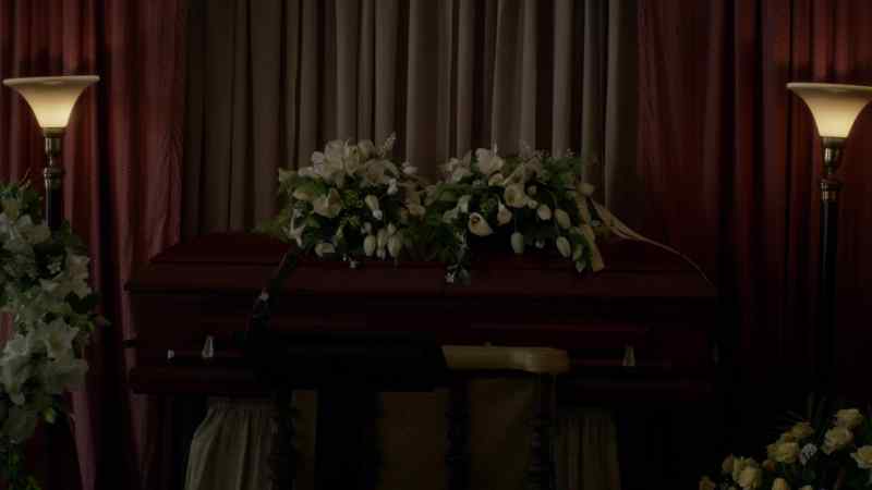 [solemn music from funeral organ]