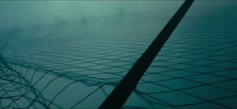 [somber piano music]