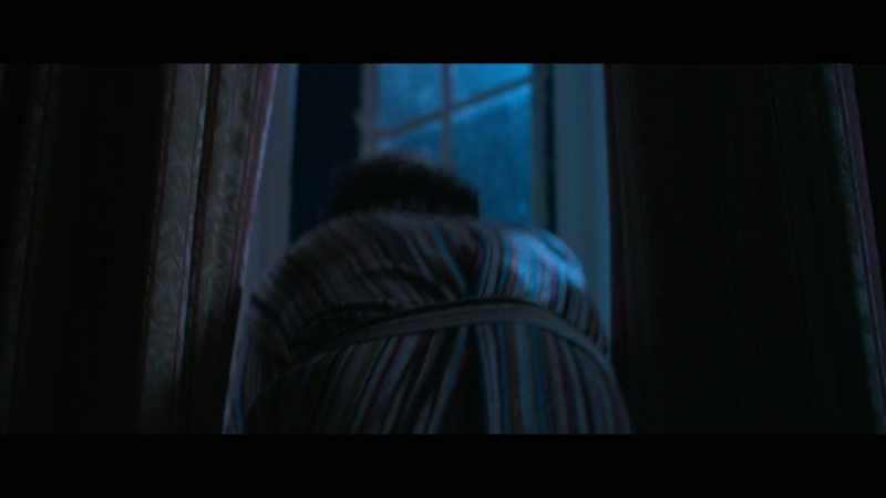[sombre music playing]