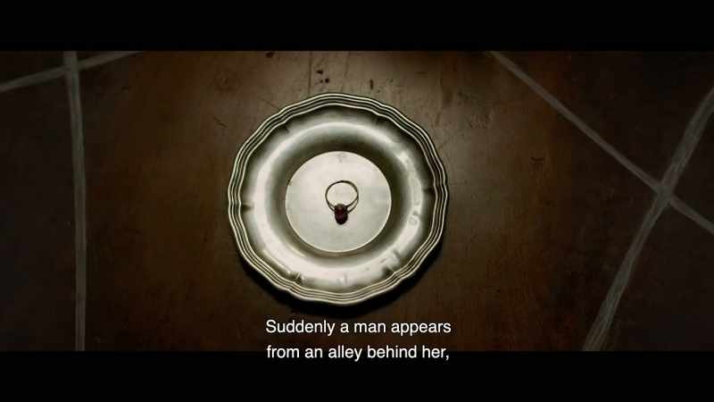 Suddenly a man appears from an alley behind her