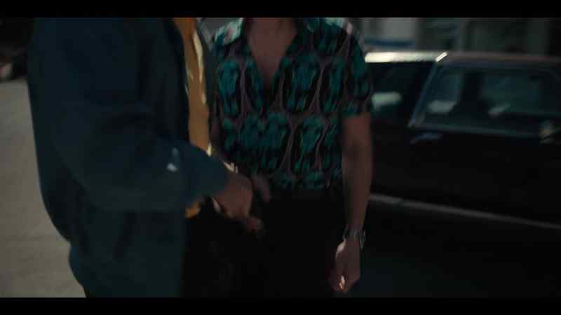 Table in back. Blue shirt