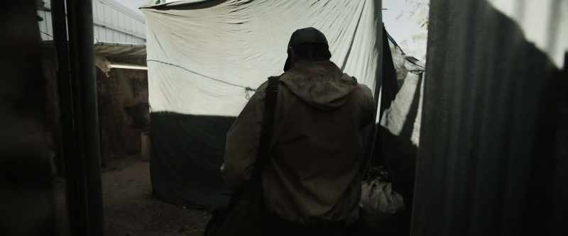 [tarps rustle in wind]