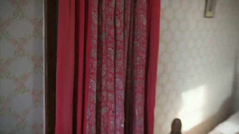That curtain's moving. What's behind that?