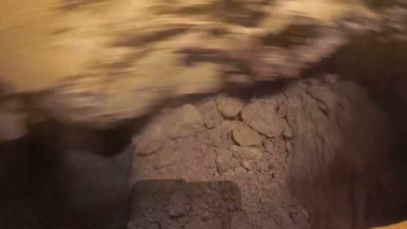 The arm is churning through the dirt