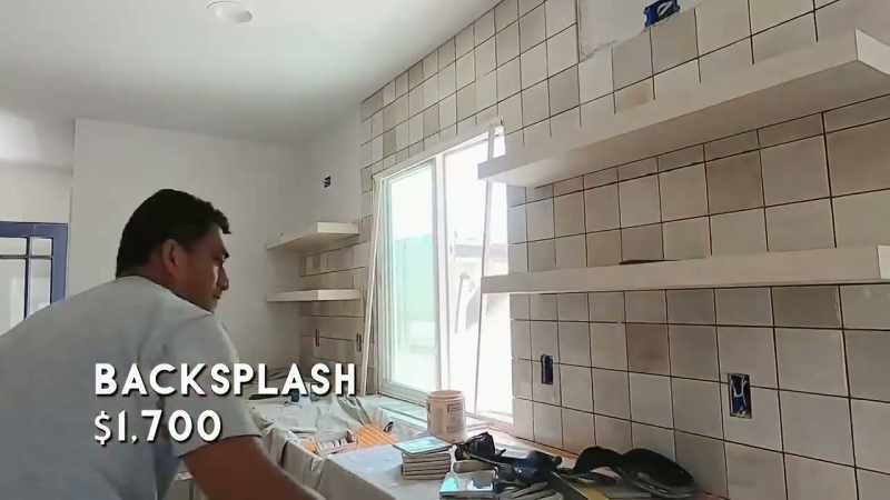 The backsplash in the kitchen is being installed