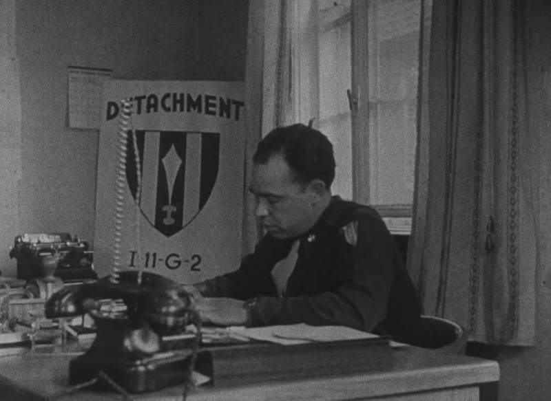 The denazification officer is a hatchet man