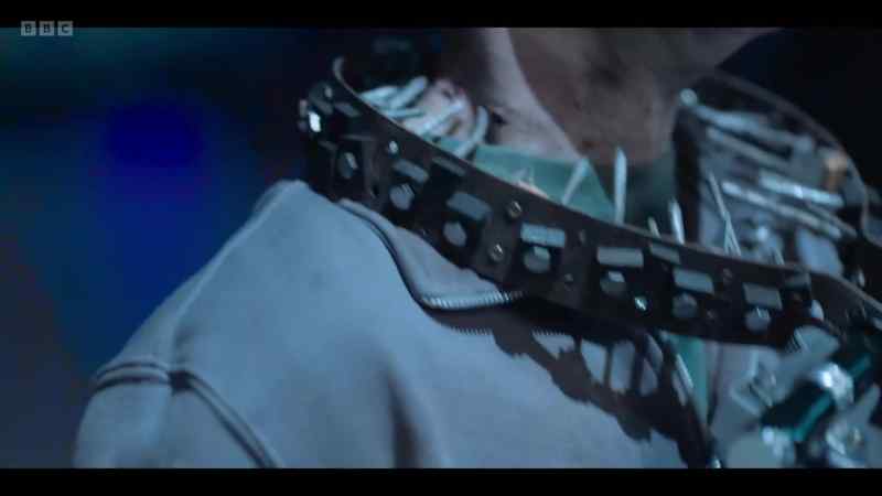 The device is around Alastair's neck with a wire