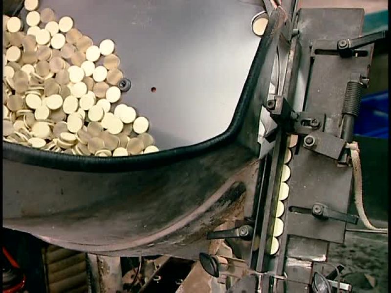 THE EQUIPMENT THEN TRANSFERS THE BLANK ONTO A SECOND CAROUSEL