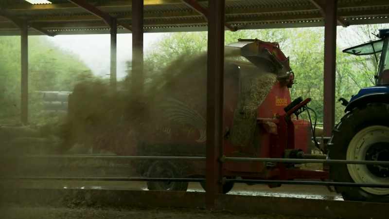 The farmer drives the tractor along