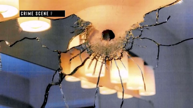 The first gunshot ends up hitting the bathroom mirror