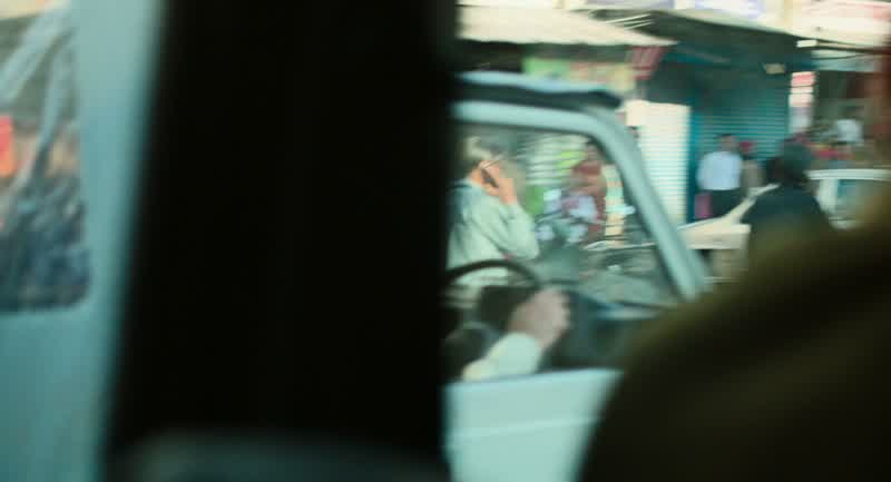 The guy with the phone in the white car
