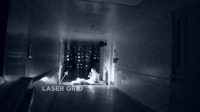 The light source that is pointed towards the end of the hall
