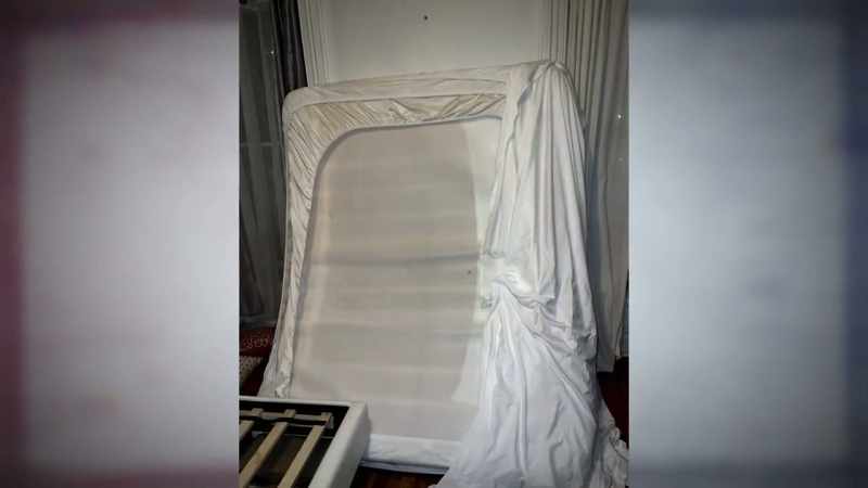 The mattress being pulled over Aliza's face