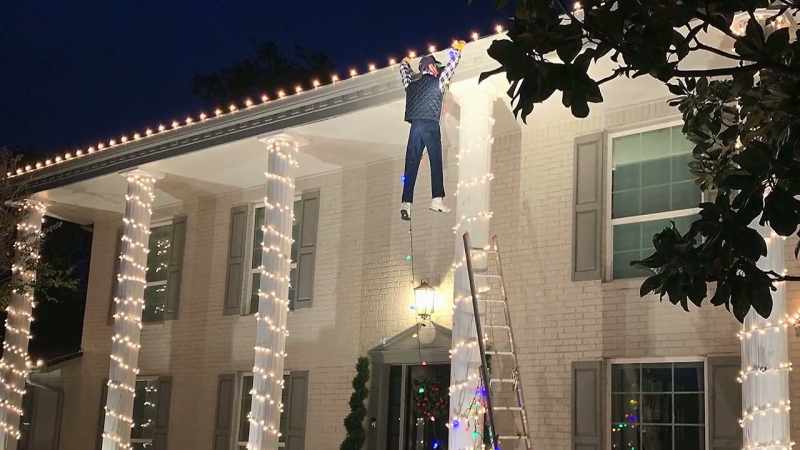 The neighbor hanging from the roof