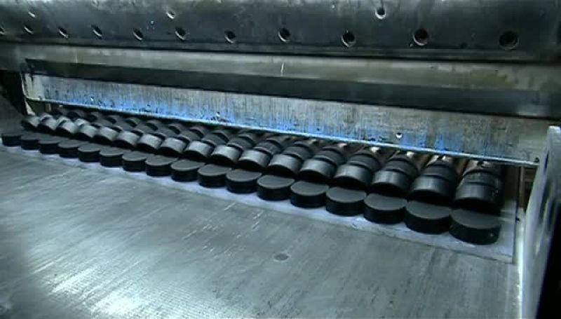 THE NEXT MACHINE SLICES EACH LOG LIKE A LOAF OF BREAD