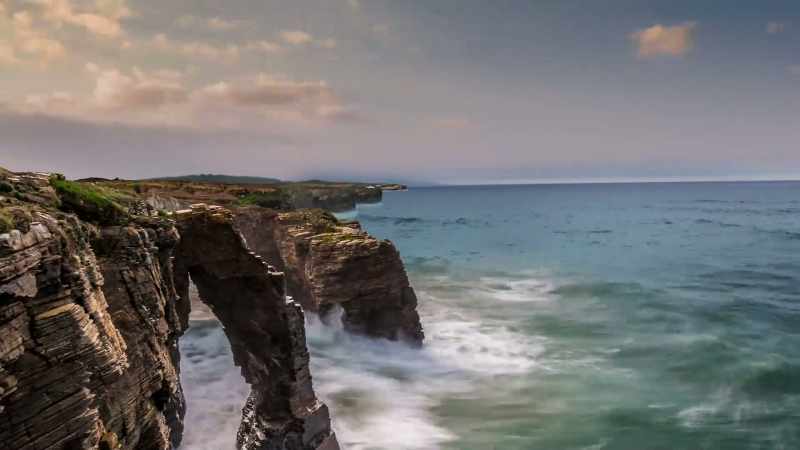The rate at which the waves reshape the rock