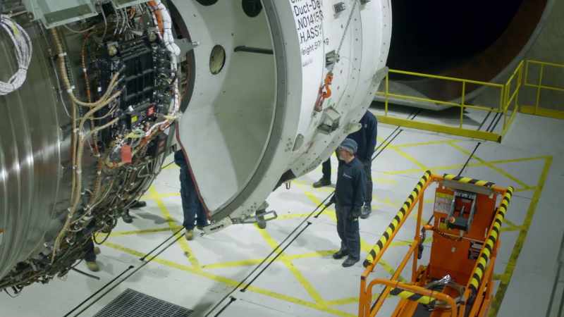 The team carefully inspects the engine