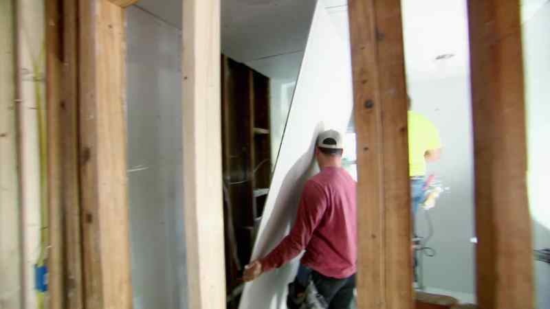 The team gets to work, laying fresh sheetrock