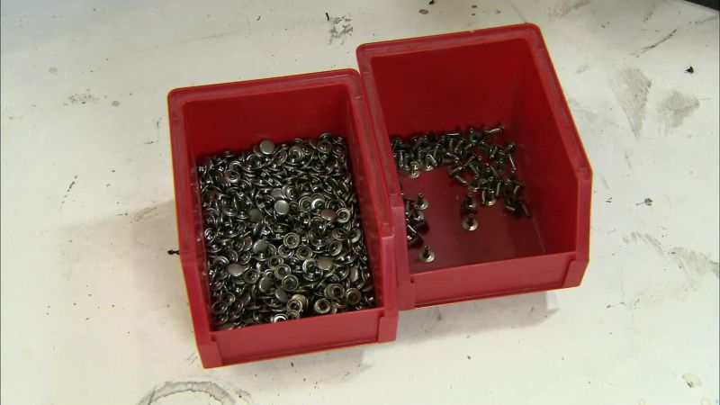 THEN HE ATTACHES THE SECOND PART OF THE RIVETS