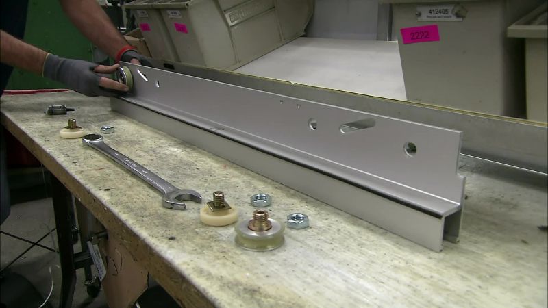 THEN, THEY ASSEMBLE THE DOOR HANGER