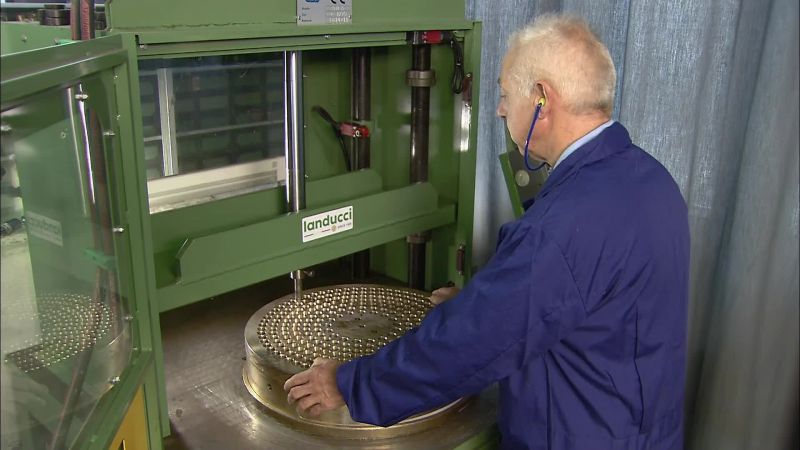 THEN, WITH A HYDRAULIC PRESS AND PUNCH