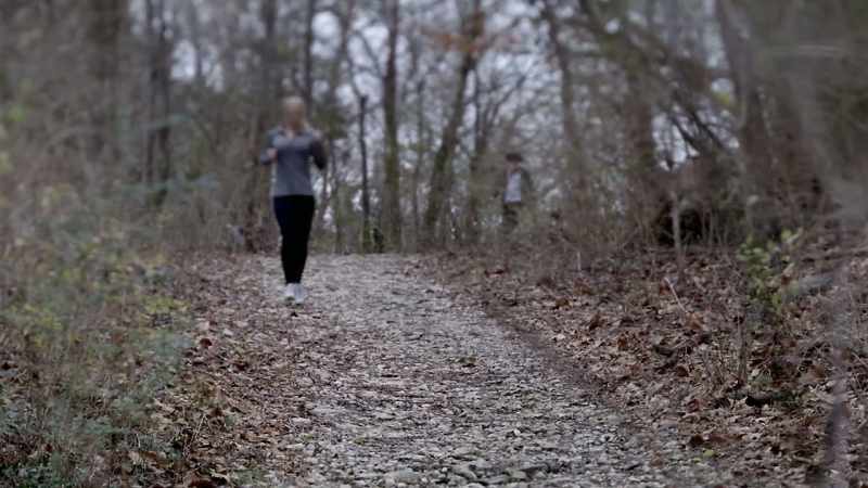 THERE IS A YOUNG HISPANIC MAN, GAINING ON HER
