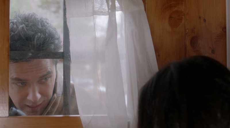 There should be a desk by the window with a quill pen