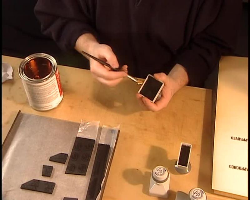 THEY GLUE THE STAMPS BY HAND