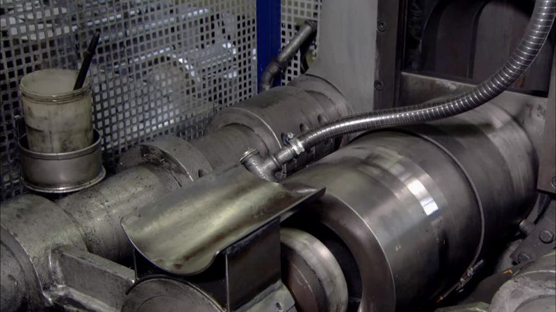 THEY LOAD EACH CURED BLOCK INTO A HYDRAULIC PRESS