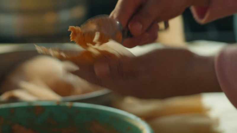 To make the casing, we spread the dough onto corn husks