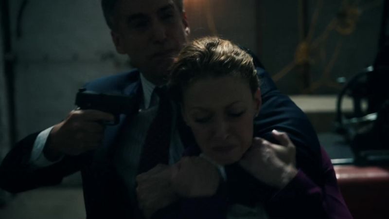 Toss the weapons or she dies!
